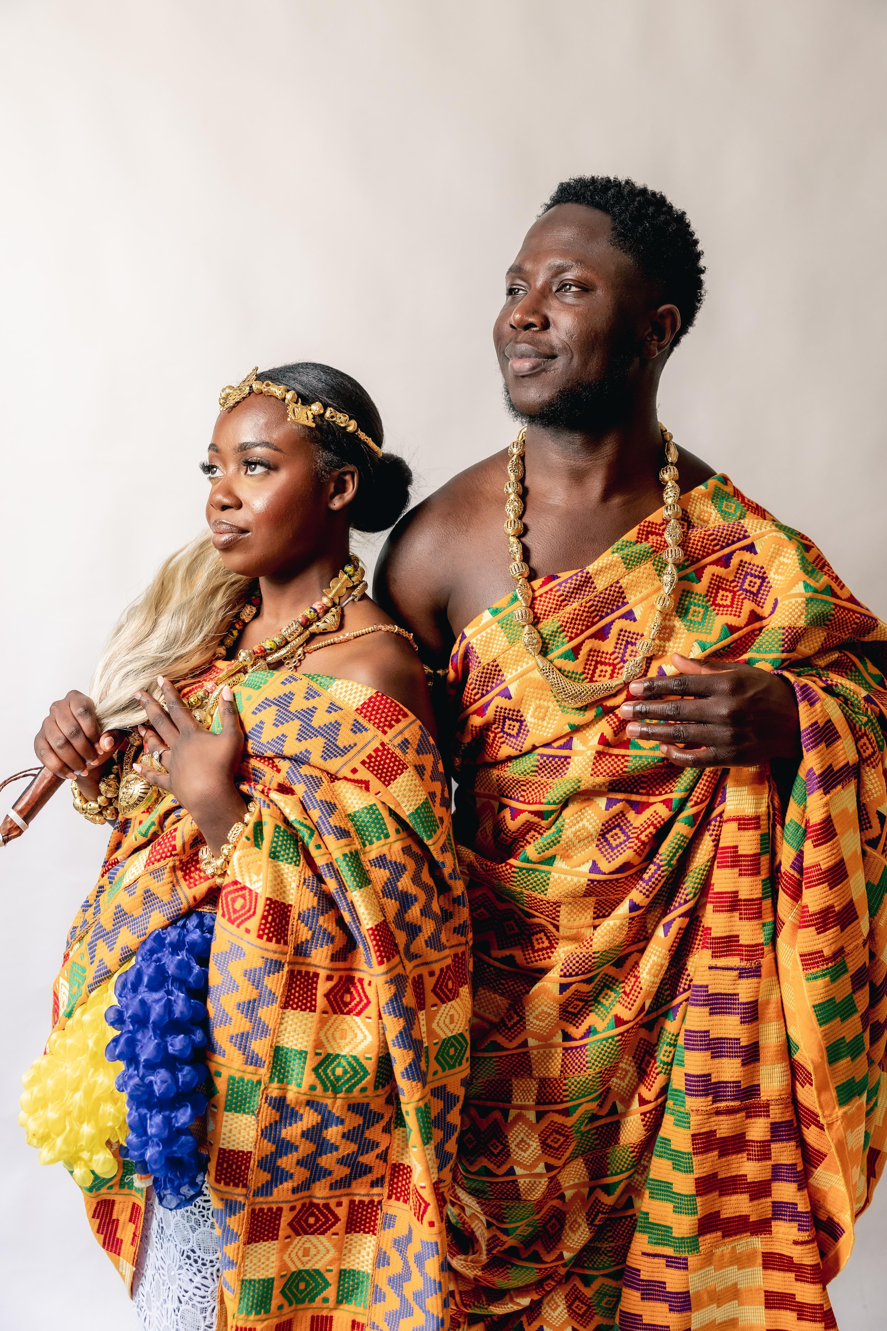 A couple wearing traditional Ghanaian Kente and gold jewellery