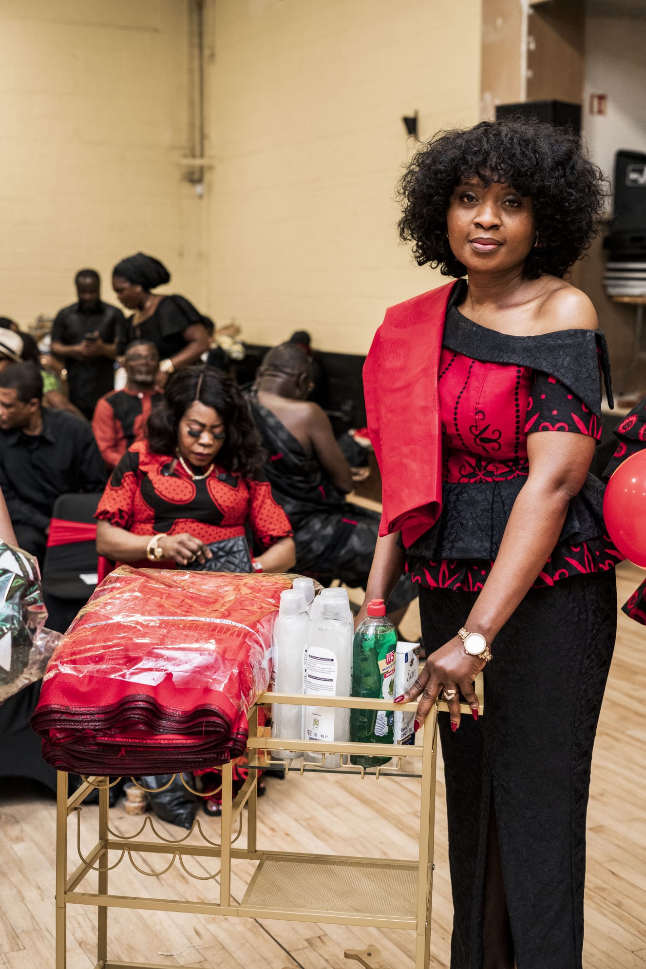 A woman dressed in coordinated red and black at a community event