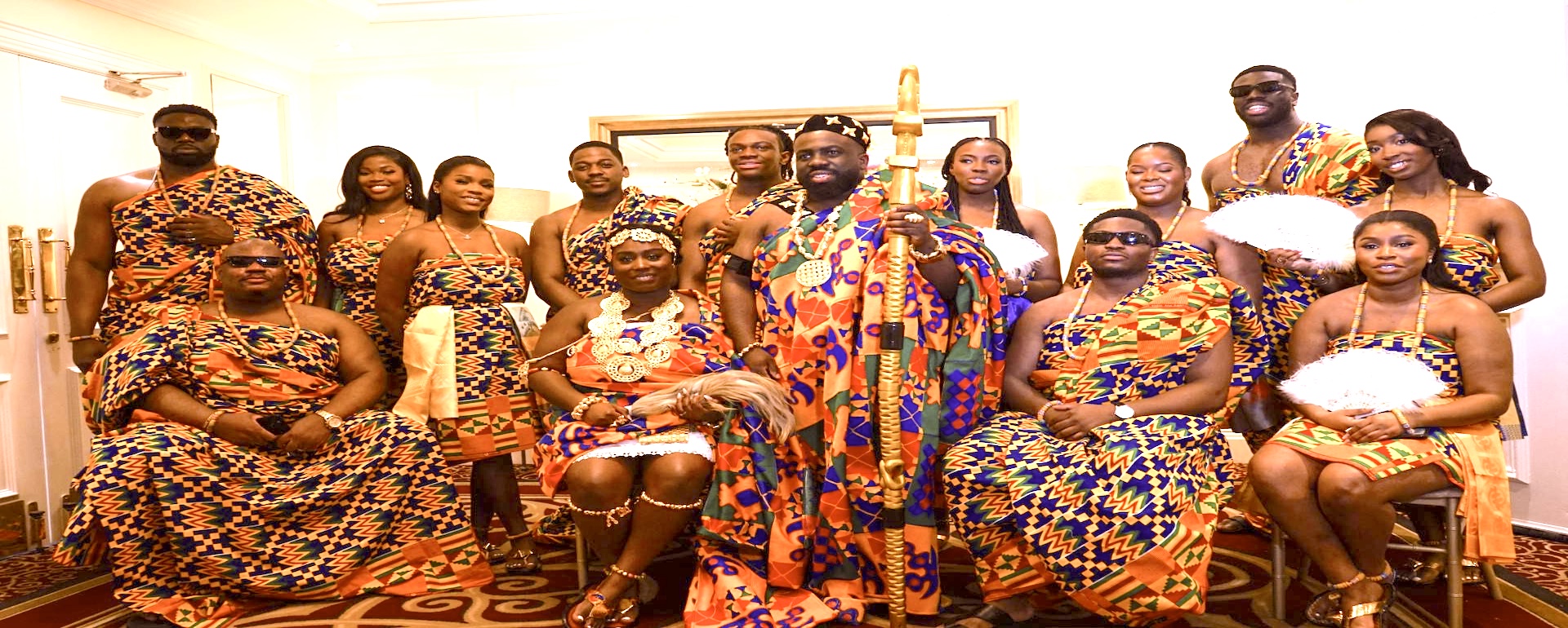 A community celebrating together in colourful Ghanaian traditional attire