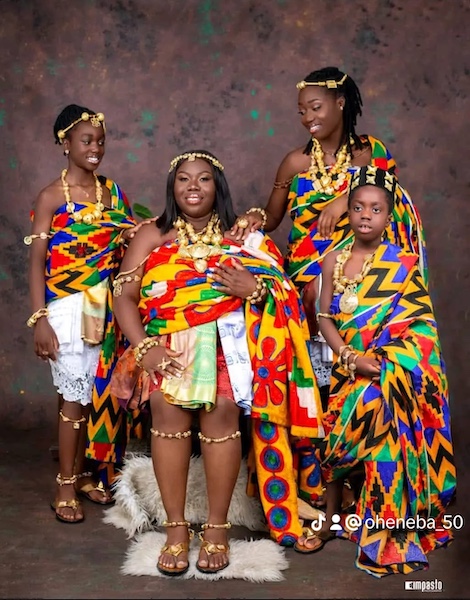 A family wearing colourful Ghanaian traditional attire